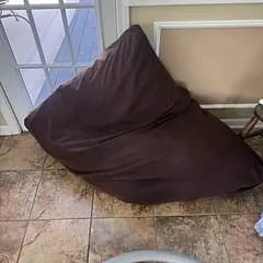 Large brown floor-cushion dog bed cleaned in the same visit as the rugs