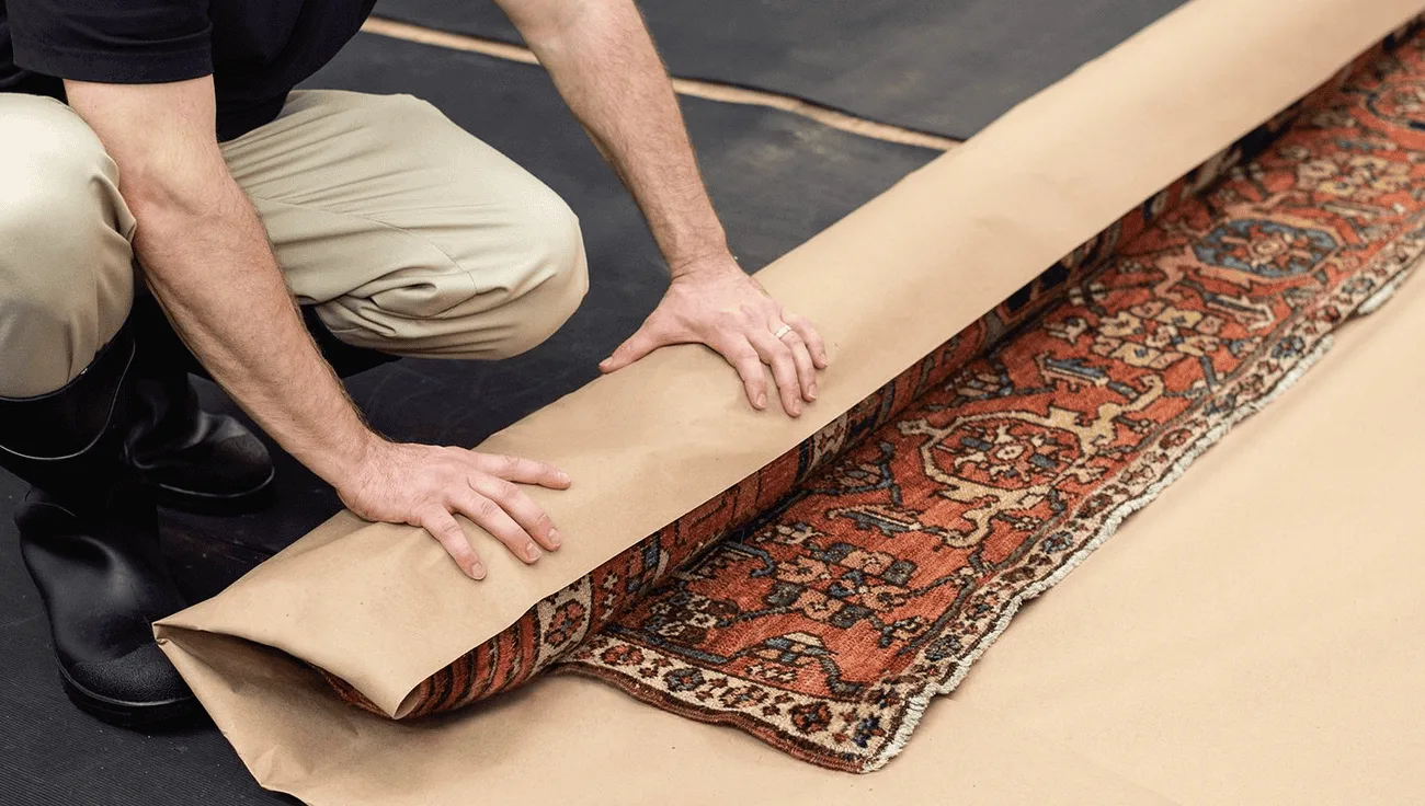 Cleaned oriental rug rolled and wrapped, ready to be returned
