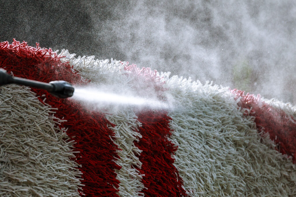 close up power washing a carpet
