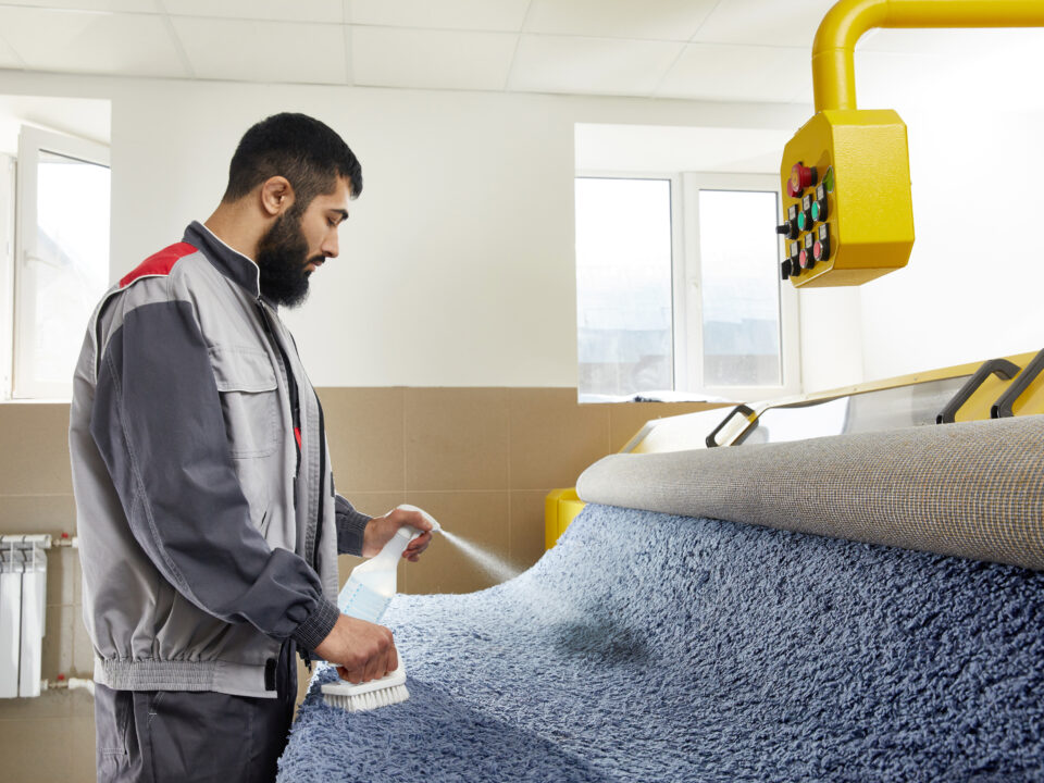 rug cleaner spraying detergent