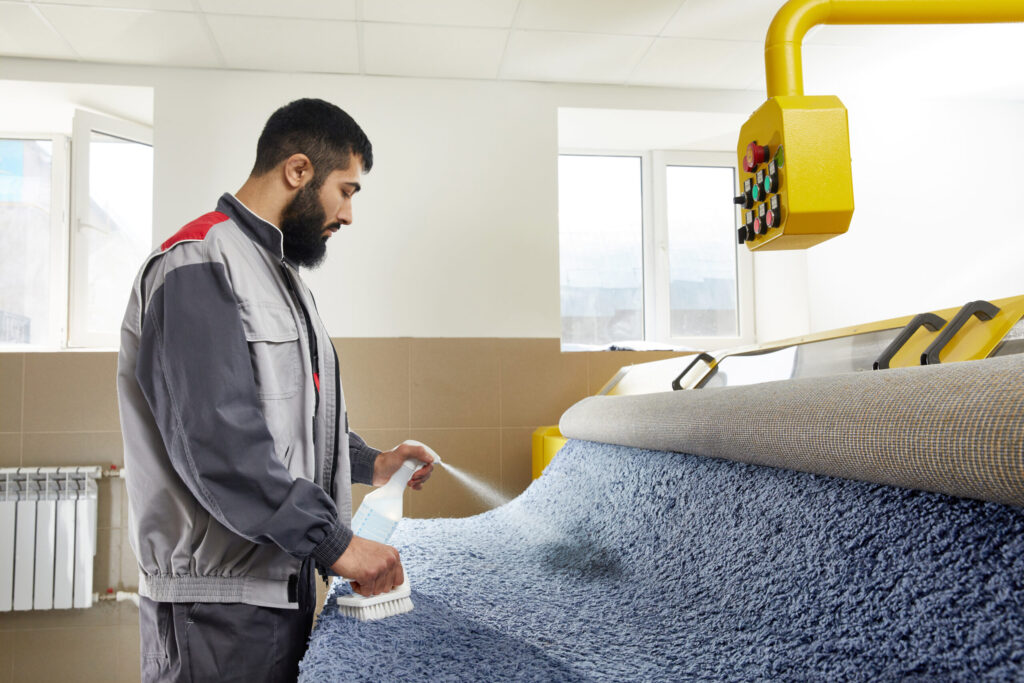 rug cleaner spraying detergent